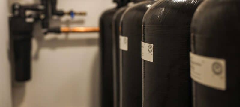 row of 4 black kinetico water softeners